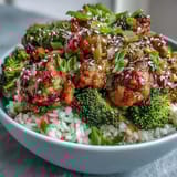Golden turkey glaze simmers with ginger and garlic in a warm bowl topped with green onion and sesame seeds.