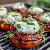 Arugula salad topped with grilled peach wedges, creamy burrata, and tangy balsamic drizzle for a fresh, Italian-inspired summer dish.