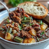 Slow-simmered Kentucky Derby Burgoo Stew, a savory Southern classic, served steaming hot.