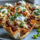Golden-baked wonton taco cups filled with seasoned ground beef and melted cheese.