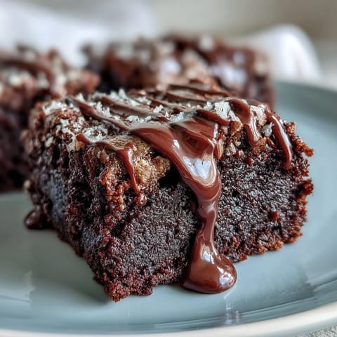 Fudgy mini brownie bites decorated with sweet white icing to look like baseballs, great for tailgates or kids' sports events.  